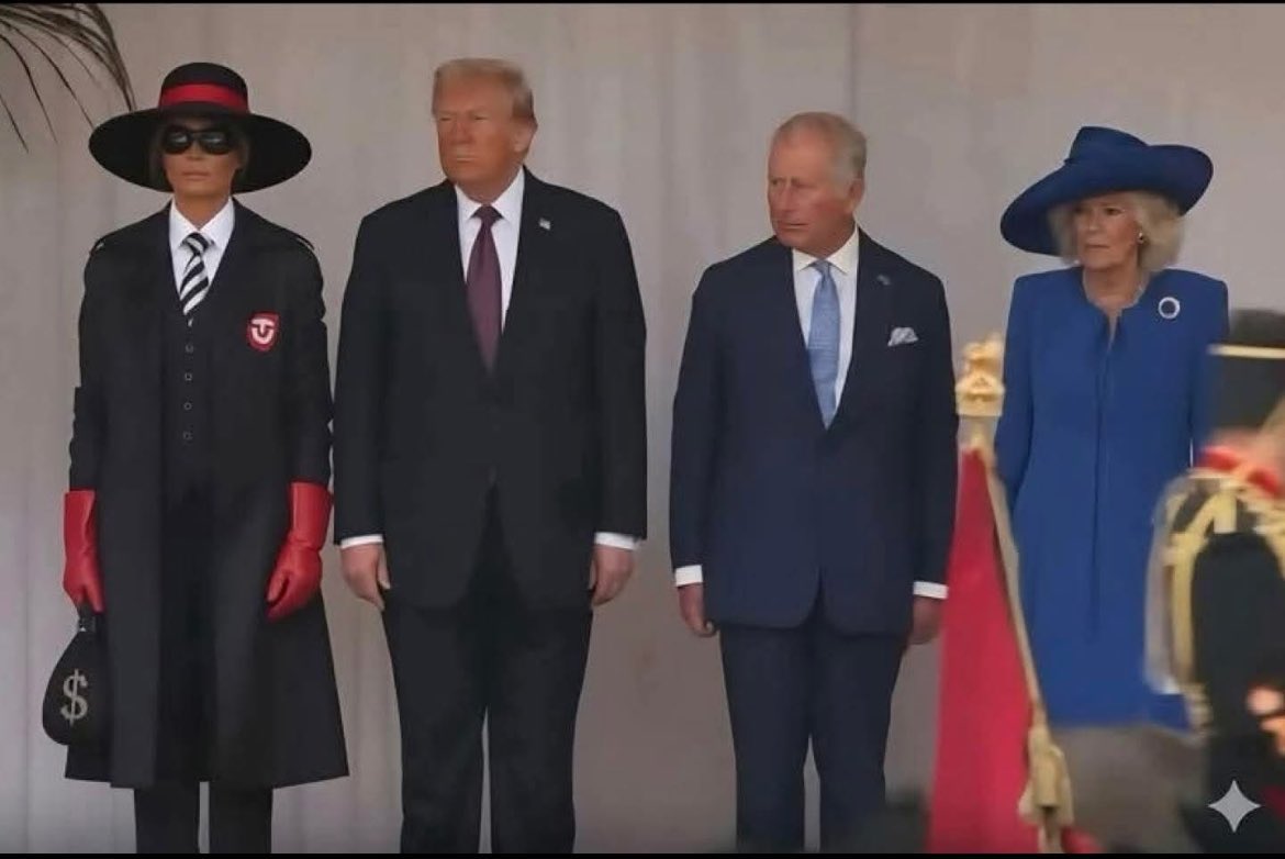 NEW IN BURGER REICH FASHION:

Our Burger Führer Donald Drumpf is visiting the King of the House of Saxe-Coburg und Gotha in England. He’s brought along his First Lady Dame Melania, who’s dressed in the HAMBURGLAR REGALIA as diplomatic etiquette dictates. What a stately look!