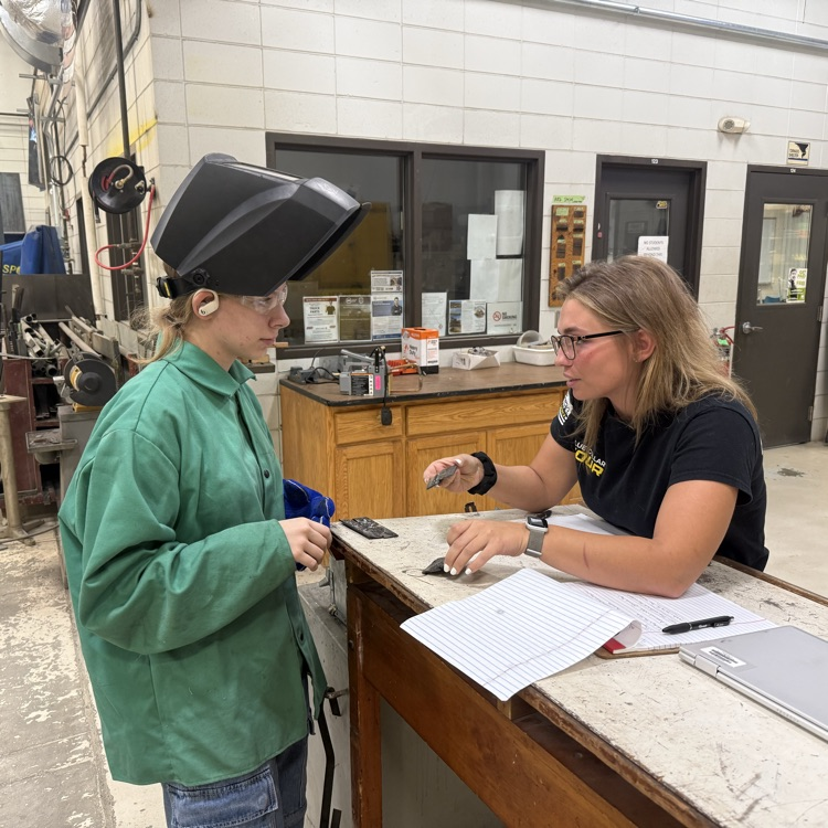 It's a wonderful day out at Harry Hopkins. Our Instructional Assistant, Ms. Carter is giving Valerie instruction on her Overlap weld.