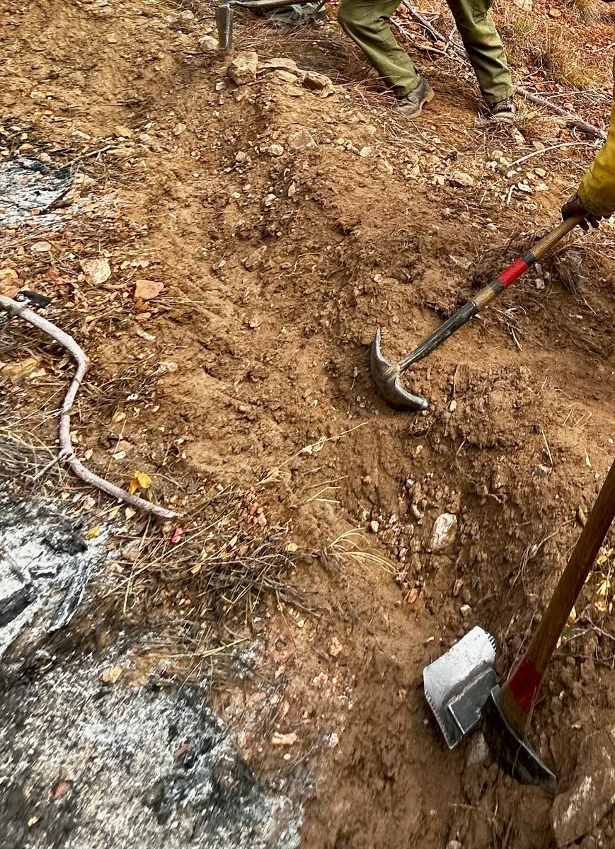 SDWF handcrew cutting fireline at a recent Black Hills fire. First person breaks ground-moves forward, next person scrapes deeper-moves forward, etc until line is cut. Often rugged, rocky, lots of roots. Not glamorous, but fire after fire, they get it done helping #keepSDsafe.
