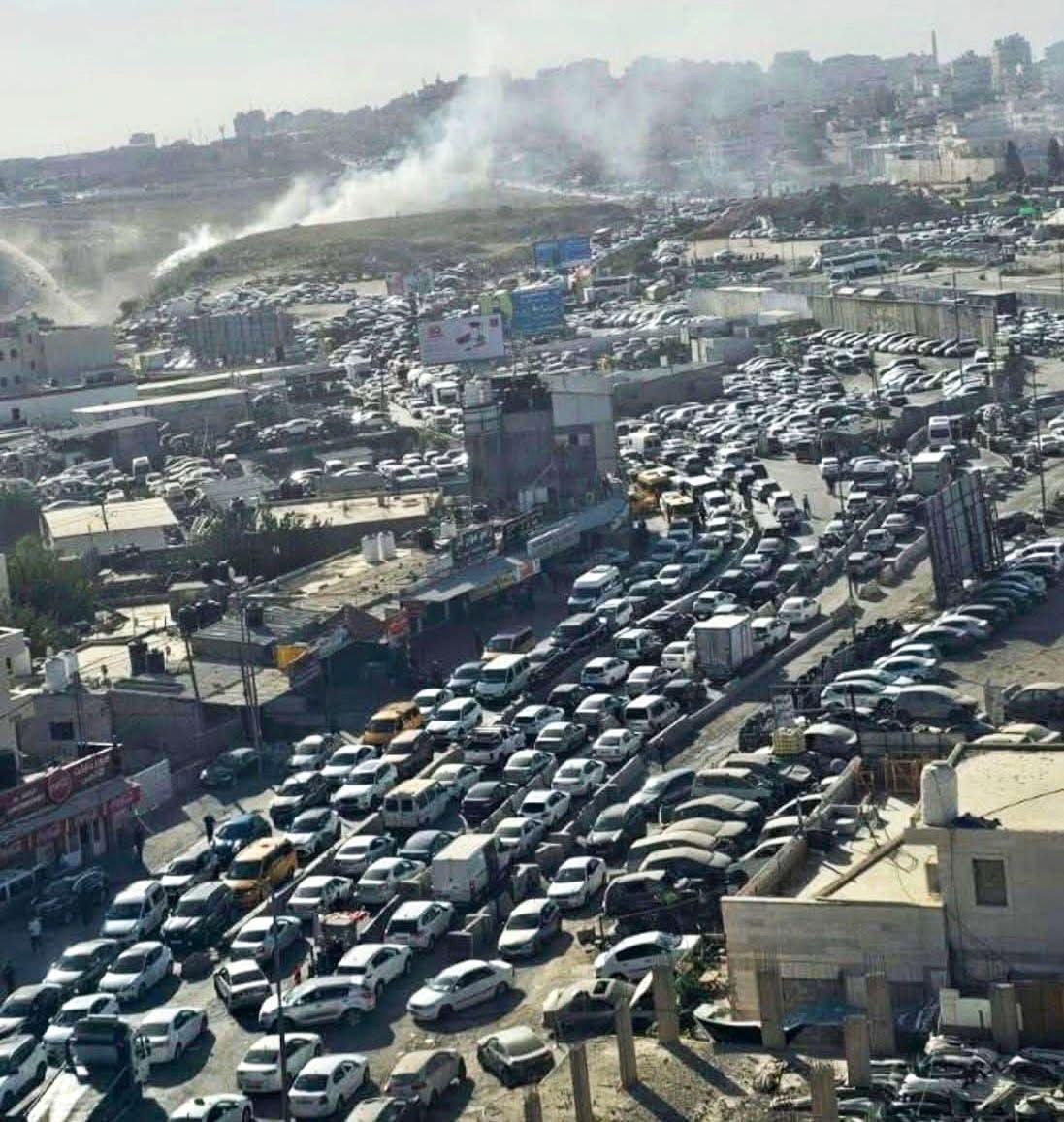 Thousands of vehicles are seen queueing this morning at the Israeli military checkpoint of Qalandia, north of occupied Jerusalem, as the Israeli occupation army tightens restrictions on the movement of Palestinians in the area.