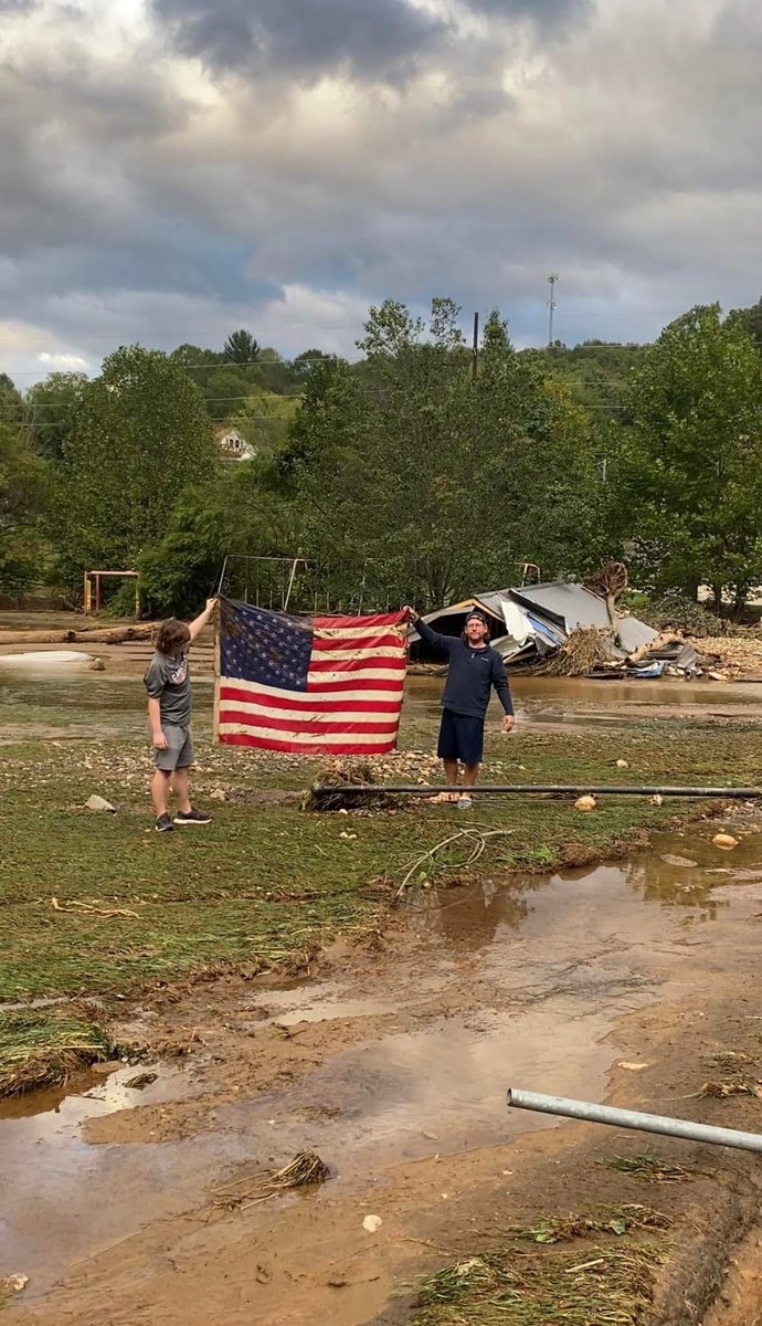 WLOS_13's tweet photo. YOUR HELENE STORY: "My husband, Seth, and our son, Landon, saving the flag at Micaville Elementary," Jessica Miller said.

Hear more stories of survival, heartbreak, and resilience from those who lived through Helene:  https://t.co/GSJ13txYrF https://t.co/a8FKiGgnFw