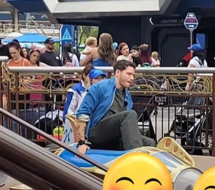 Why is this giant man trying to get on this tiny ride?