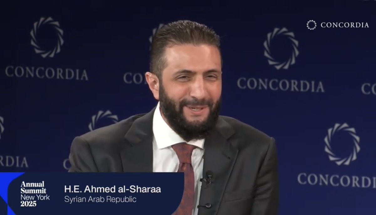 azelin's tweet image. Sharaa’s reaction after Petraeus asks him about being on opposite sides in the Iraq war and him being imprisoned while Petraeus was fighting against al-Qaeda in Iraq