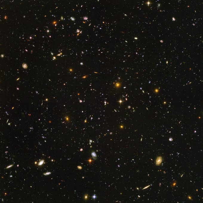 The Hubble Ultra Deep Field reveals nearly 10,000 galaxies in a patch of sky no larger than a tenth of the Moon. This cosmic core sample shows galaxies as they were just 800 million years after the Big Bang.