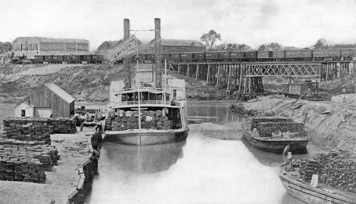 TracesofTexas's tweet photo. Speaking  of the Houston ship channel and 1876, here's a nifty shot of the  steamboat "Lizzie" on the channel back in that year.  It looks to me  like it's loaded with logs.   The other boats, the big warehouses in the background, the train on  the trestles in the background ... there's quite a bit to take in here.   Really a cool shot!