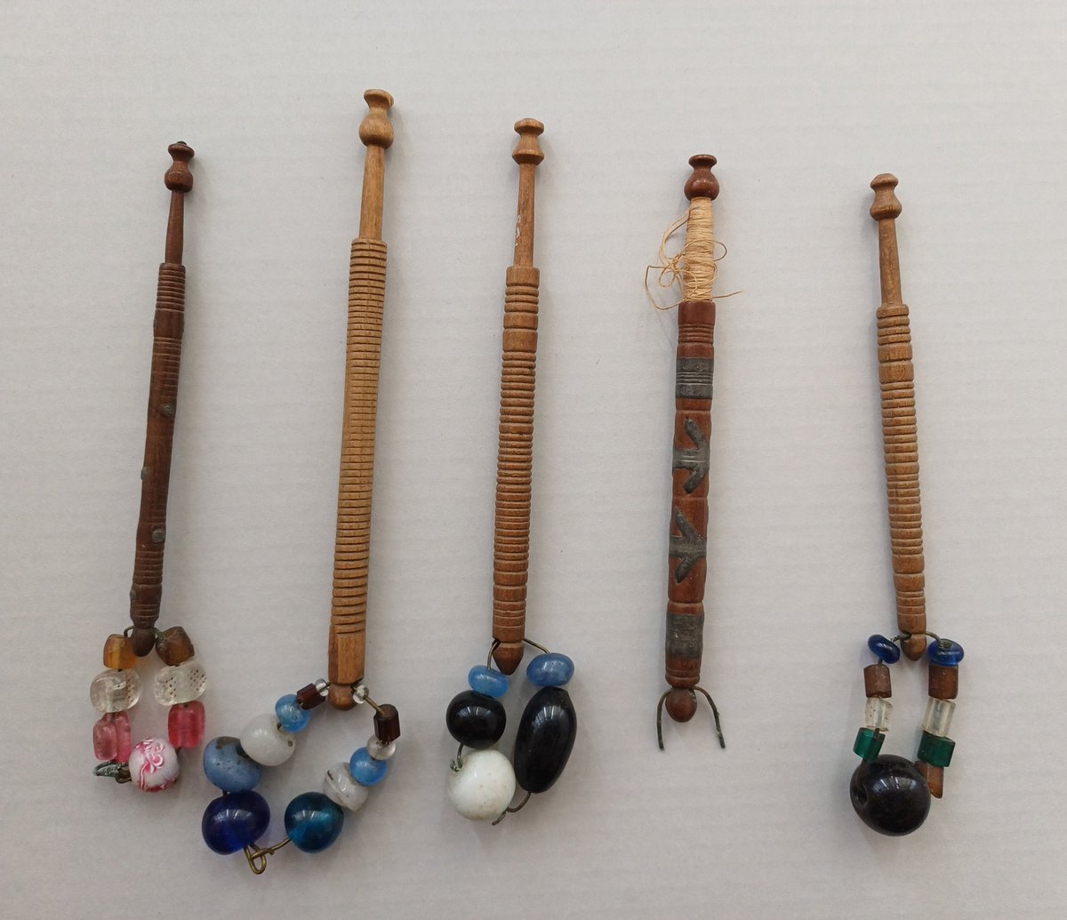 These five Midlands lace bobbins have been in our collections since the 1950's.

Midlands bobbins are characterised by the beaded 'spangle' attached to them.

Although bobbin lace is now officially classified as an endangered craft there is still an active Thurrock  community.