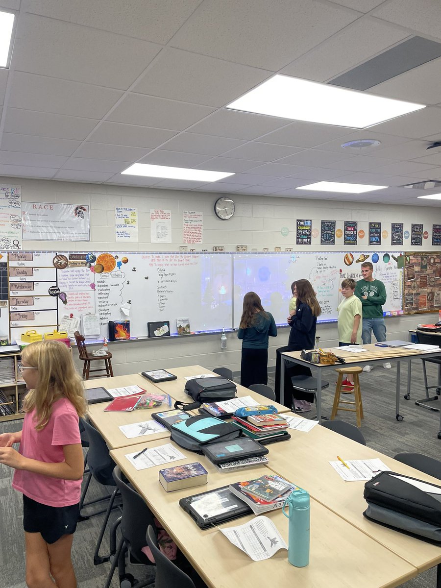 Mrs. Lecher teaching her 6th grade Science class how to evaluate data from their Paper Airplane project using double bar graphs.
