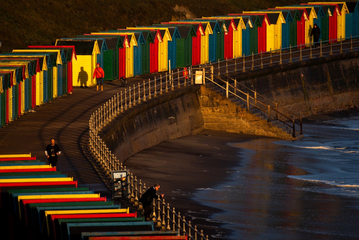 People soak up the sunrise on the promenade at Whitby, North Yorkshire. 

Neil Squires/Alamy Live News