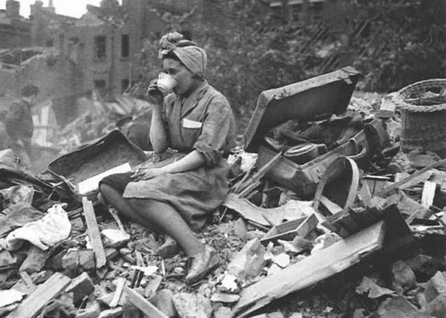 A woman drinking tea in the aftermath of a German bombing raid during the London Blitz, 1940.