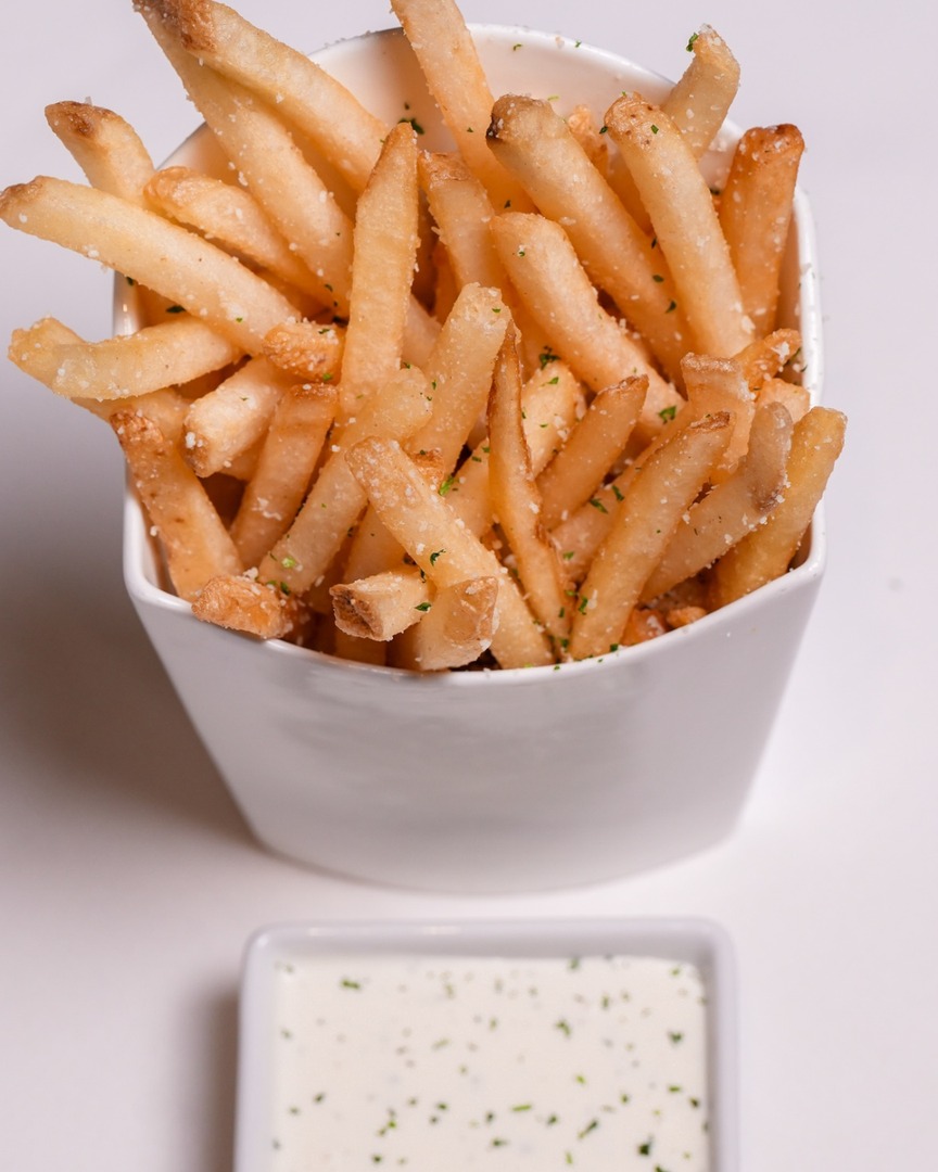 Golden and perfectly crisp, our French Fries are topped with pecorino, a drizzle of white truffle oil, and a hint of rosemary. A timeless side with a touch of elegance.

#domsteak #steakhouse
