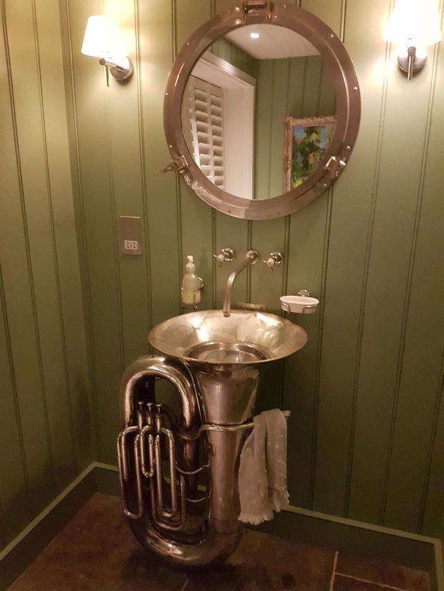 Someone turned this old tuba into a fully functioning bathroom sink.