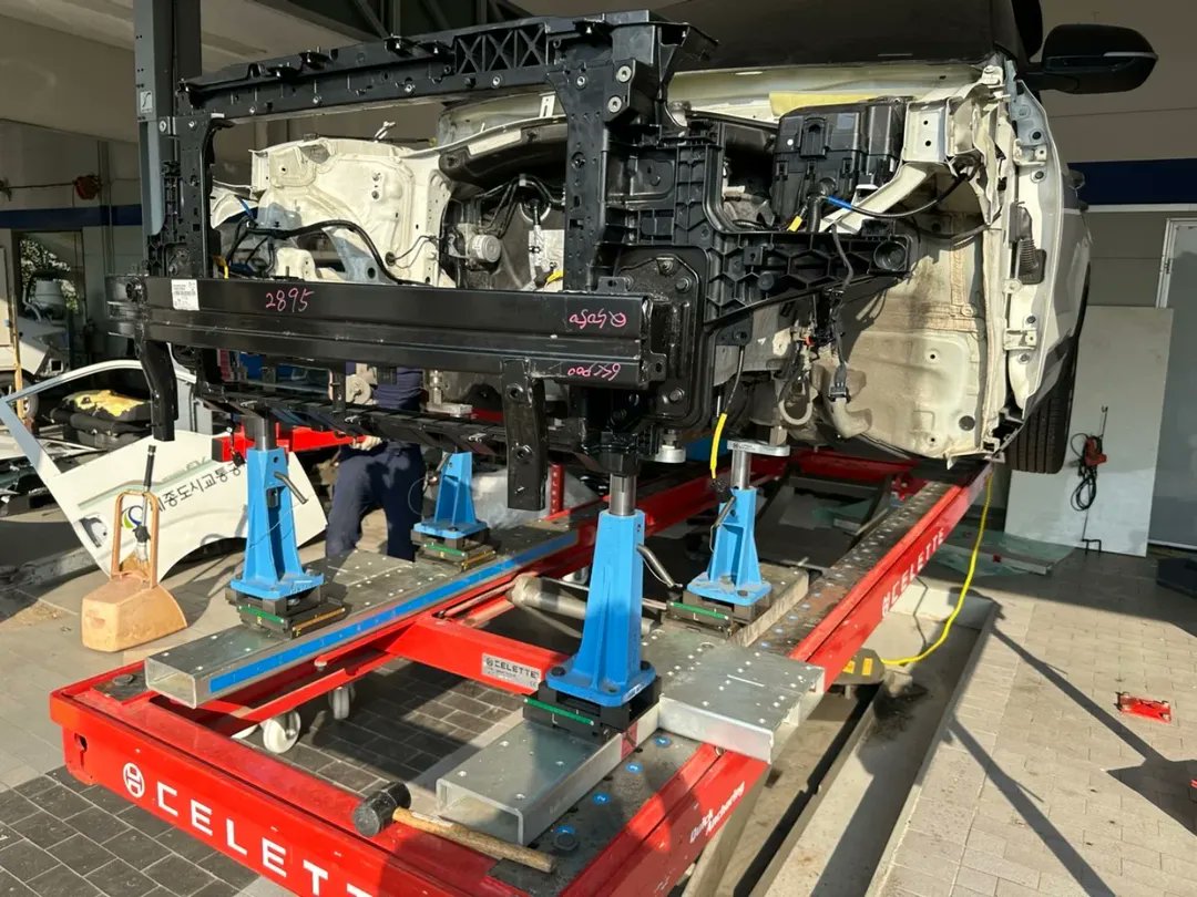 The Kia Seltos, which has front-end damage, is currently undergoing frame correction. The engine has been removed to allow proper access, and the repairs are being carried out using the Celette Universal Jigset, Cameleon system to ensure accurate alignment.