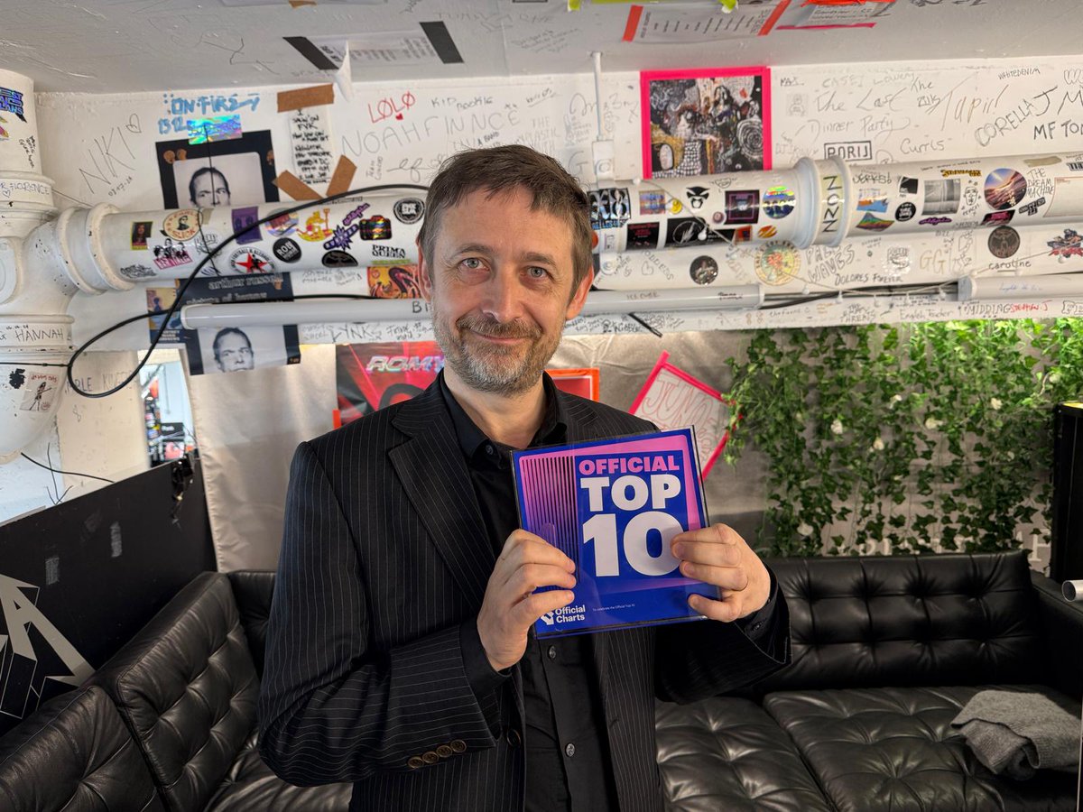 What an achievement for <a href="/divinecomedyhq/">The Divine Comedy</a> ! 

Their sixth Top 10 album, their highest positioning record since 1999, while also topping the Official Independent Albums Chart with #RainySundayAfternoon 🌧️

Here is lead singer #NeilHannon proudly clutching the Official Top 10 Award
