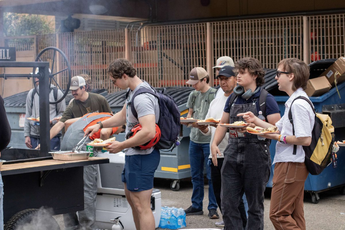 PolyEngineering's tweet image. Student shop techs served food hot off the grill Friday while breaking in the brand-new barbecue pit they spent the summer building. Lunch options included burgers, hotdogs and veggie burgers, served with all the fixings.