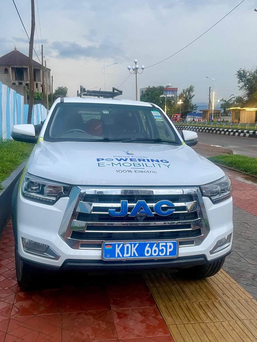 KenyaPower's tweet photo. Yesterday, day 6 of #RoadtoAddis, time Travel and Green Hills
1738 hrs: A pause for top-up charging in Dilla.

It might be 10 October 2025 in the rest of the world, but here in Ethiopia, it’s 2 Tikimt 2018, a reminder that this journey crosses not only borders but calendars. And so, we press on with the Road to Addis.

After a late night of charging and planning, the team allowed for a slower start. This was a much-needed pause to regroup and recharge, both literally and figuratively. Once on the road, the 211-kilometre stretch from Yabello to Dilla unfolded in sweeping, green waves. The air grew cooler, the landscape softer. But with the climbs came heavier energy use; the rolling hills demanded more from the vehicles and motorcycles than the flatlands behind us.

Midway through, rain forced an unscheduled stop. With two motorcycles in the convoy, it was safer to wait it out than risk the slick tarmac. The delay added to the day’s length, but the pause brought a rare quiet, the kind that settles in only when the road decides to slow you down.

Still, the hum of the electric convoy through this lush heartland is a symbolic rhythm of persistence, each kilometre closer to Addis.
#PoweringEMobilityKE #TheFutureIsElectric #PoweringKenya #eMobility #AEW2025 ^KN