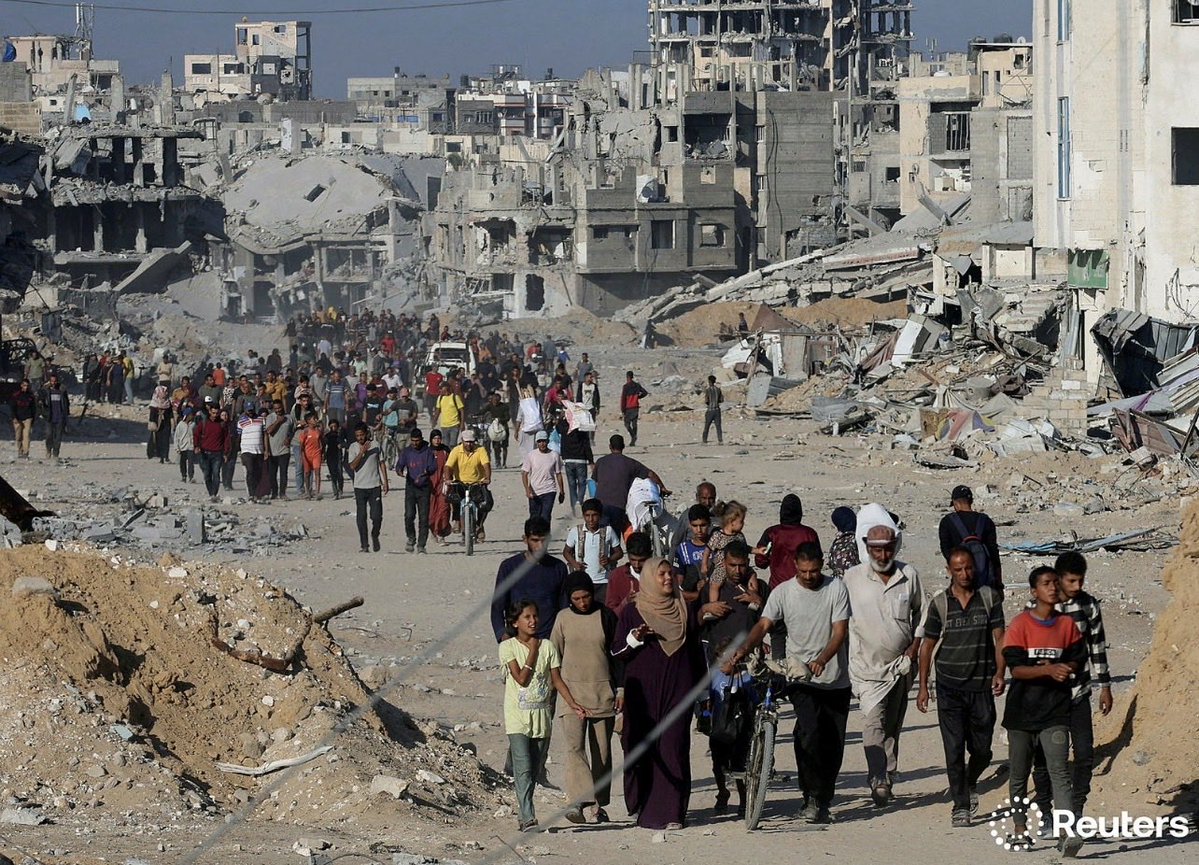 idreesali114's tweet image. Palestinians walk past rubble as they return to their neighborhood, following Israeli forces&apos; withdrawal from the area, amid a ceasefire between Israel and Hamas in Gaza, in Khan Younis, in the southern Gaza Strip October 11, 2025. REUTERS/Ramadan Abed