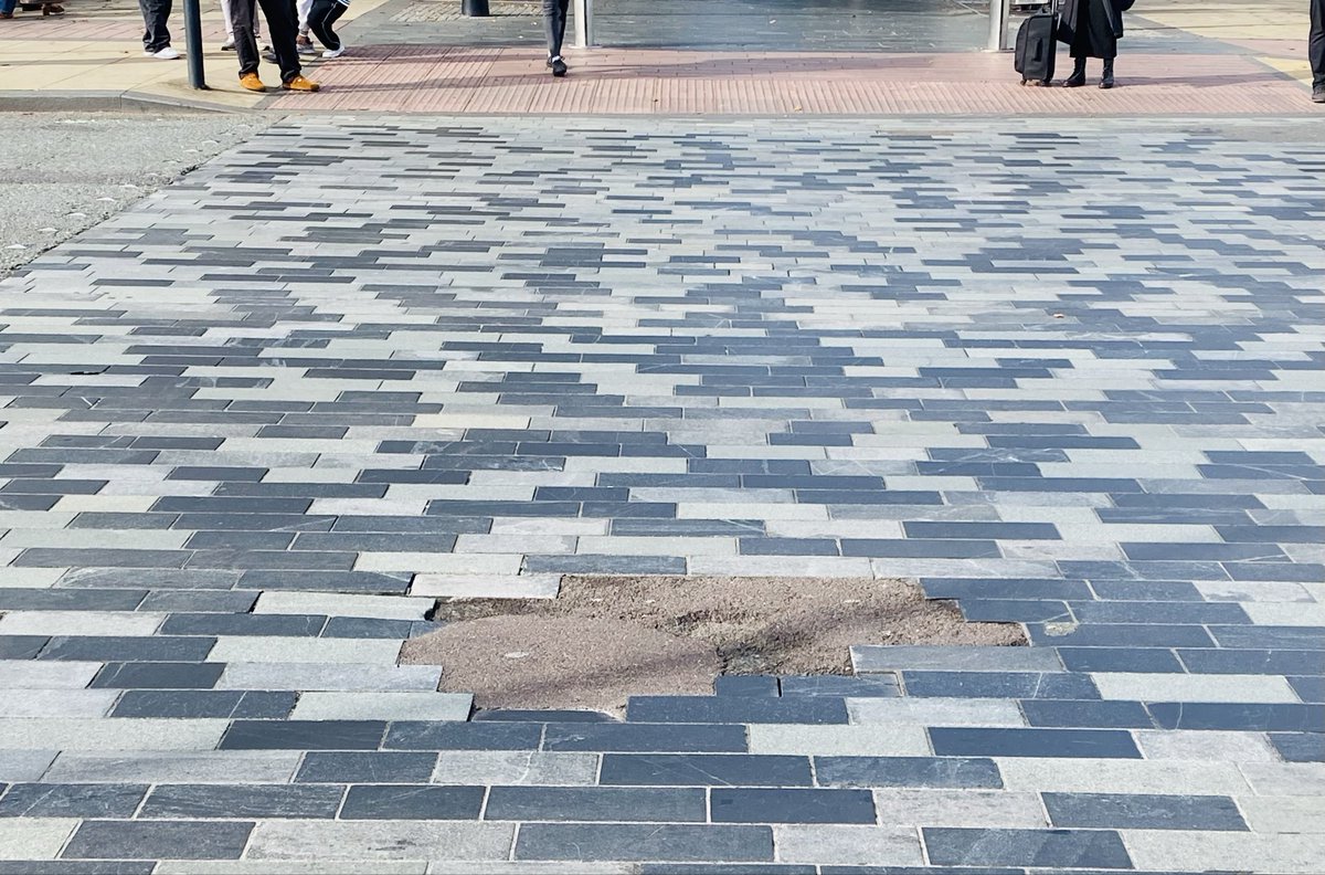A visual of “technical debt." Tarmac to repair broken tiles.