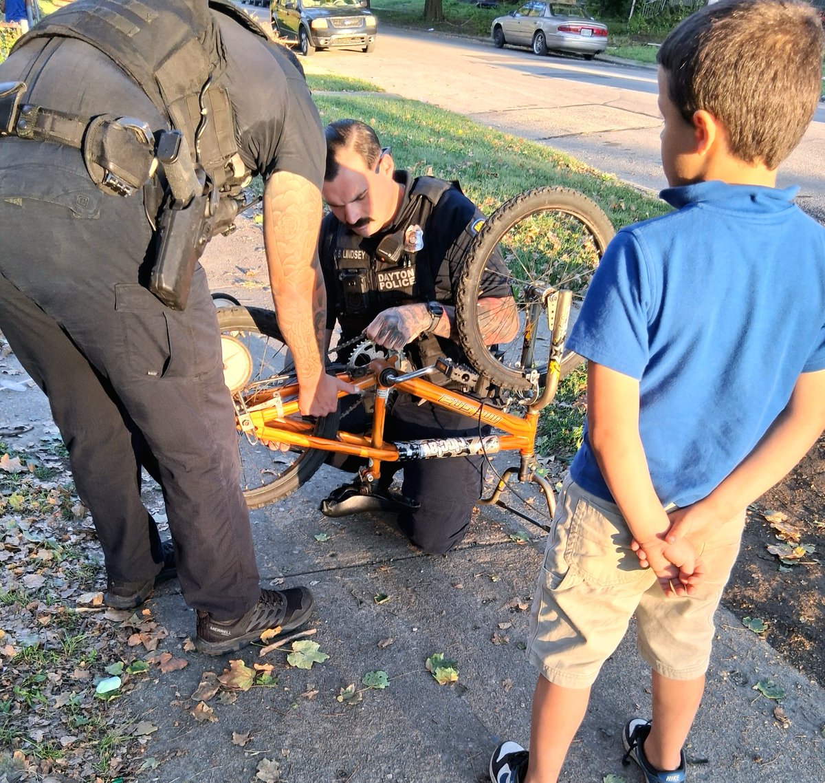 After finishing a call, Officers Lindsey and Brown were approached by a young man who needed a help fixing his bike.

The officers got the chain back on and made sure he was ready to ride again. His grandfather, took this photo, and wanted to share it with DPD and social media.