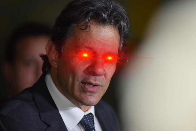 Brazilian President Luiz Inácio Lula da Silva stands in a suit with a dotted tie, mouth slightly open as if speaking, against a blurred background with another person visible. His eyes are digitally edited to glow bright red with laser-like beams emitting outward, creating a meme-style intense or menacing expression. The image appears to be a modified photo from a public or official setting.