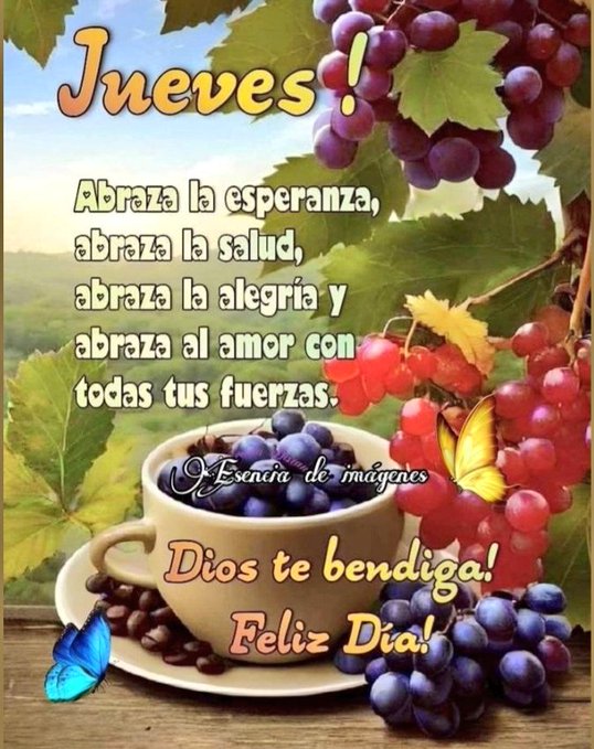 Colorful graphic text in yellow and orange reads Jues Jues Jues with exclamation, below it Abrazala esperanza, abraza la salud, abraza la alegriay abraza al amor con todas tus fuerzas in white on green background. A white cup filled with coffee sits on a saucer on a wooden surface, with Dios te bendiga Feliz Dia written on the saucer. Purple and red grapes cluster around, green leaves frame the scene, a blue butterfly perches nearby, and a scenic view with sky and foliage in background. Escena de imagenes watermark appears at bottom.