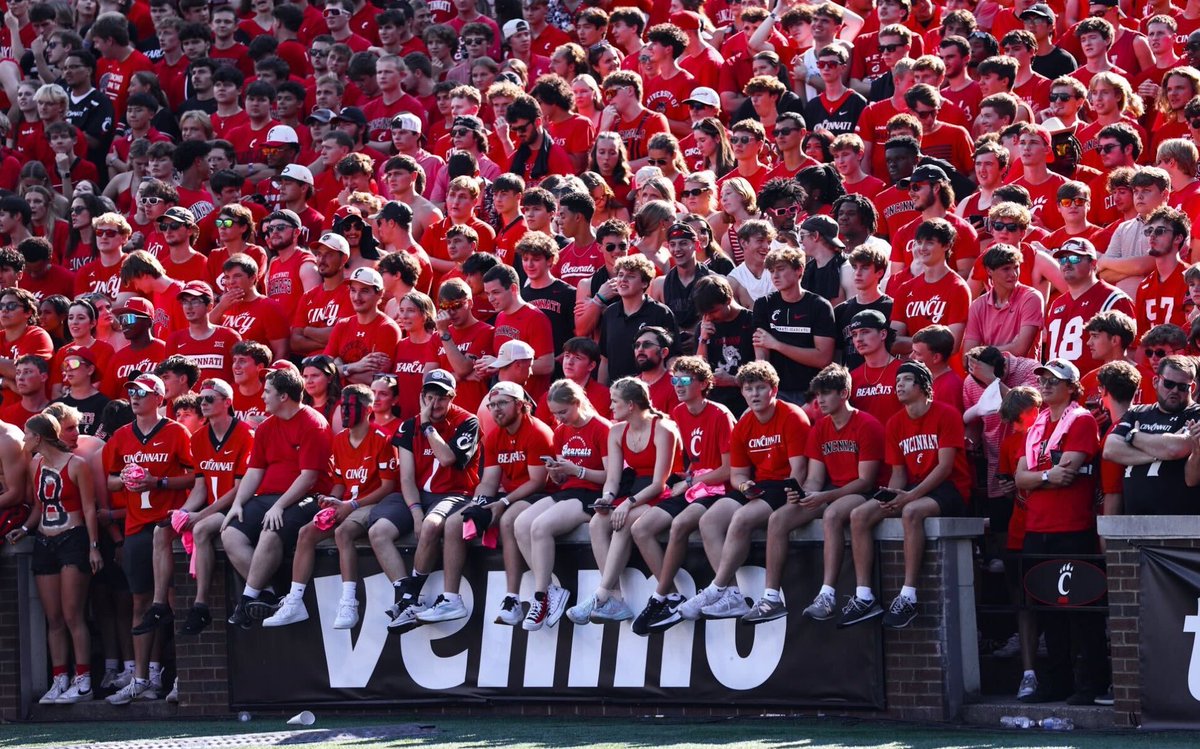 Such a great picture from <a href="/GoBearcatsFB/">Cincinnati Football</a> with the students dangling their feet over the edge of the brick wall in Nippert waiting for the game to end so they can rush the field