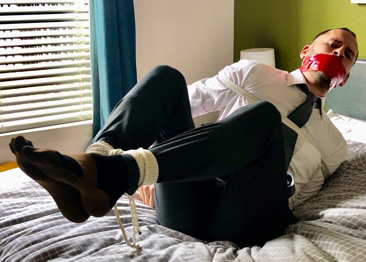#boundandgagged, with his #collarandtie working loose as he struggles against his bonds, but his other ties continue to hold him securely in #sutbondage!