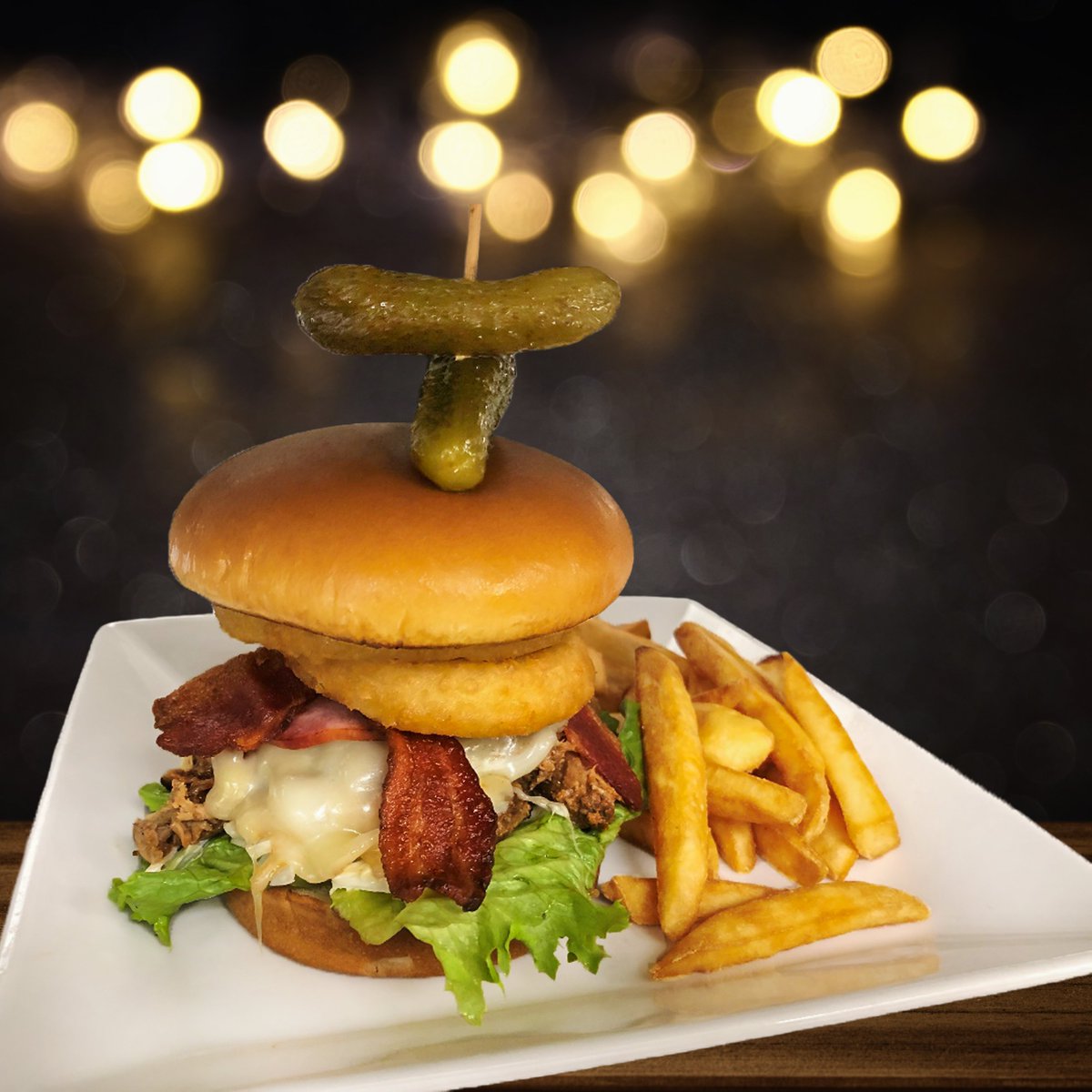 Fuel up like a pro with our Three Piggy burger available at Celly's Sports Bar &amp; Lounge! The perfect companion for every Edmonton game! 🏒🍔

Has 2 large onion rings, bacon, back bacon, pulled pork and cheese. Served as a combo with 16 oz Bud Light or Budweiser for $19.97.