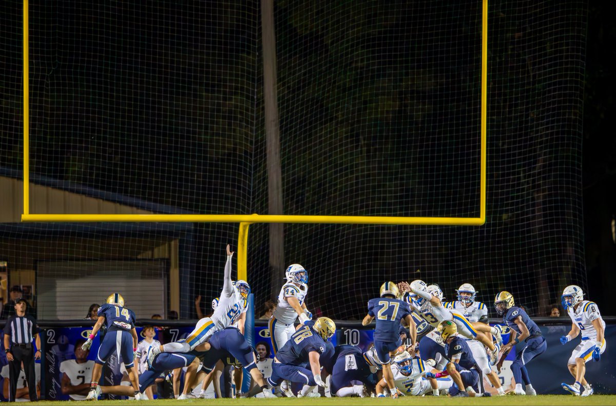 Fairhope Pirates  linebacker Nash Gearhart (#35) blows up the Foley Lions’ first-half 4th-down quick kick attempt by blocking a kick by quarterback Makai Holmes (#6) in the backfield. Image 2 shows Pirates outside linebacker Hunter Williams (#13) blocking Foley Lions place kicker