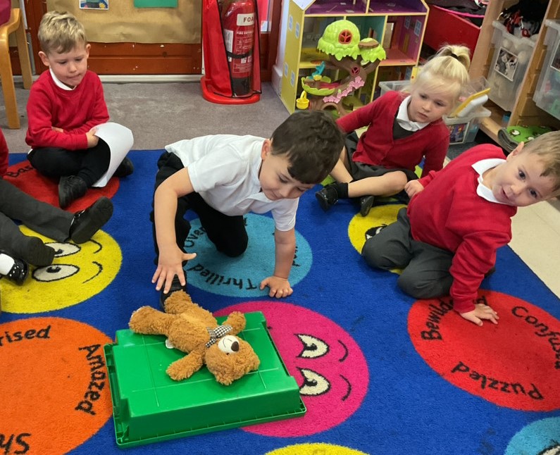 This week nursery have been learning about prepositions in math. Each child was asked to place a teddy bear in a certain preposition using a box, such as in front of, behind, under and on top of. Great job nursery!
