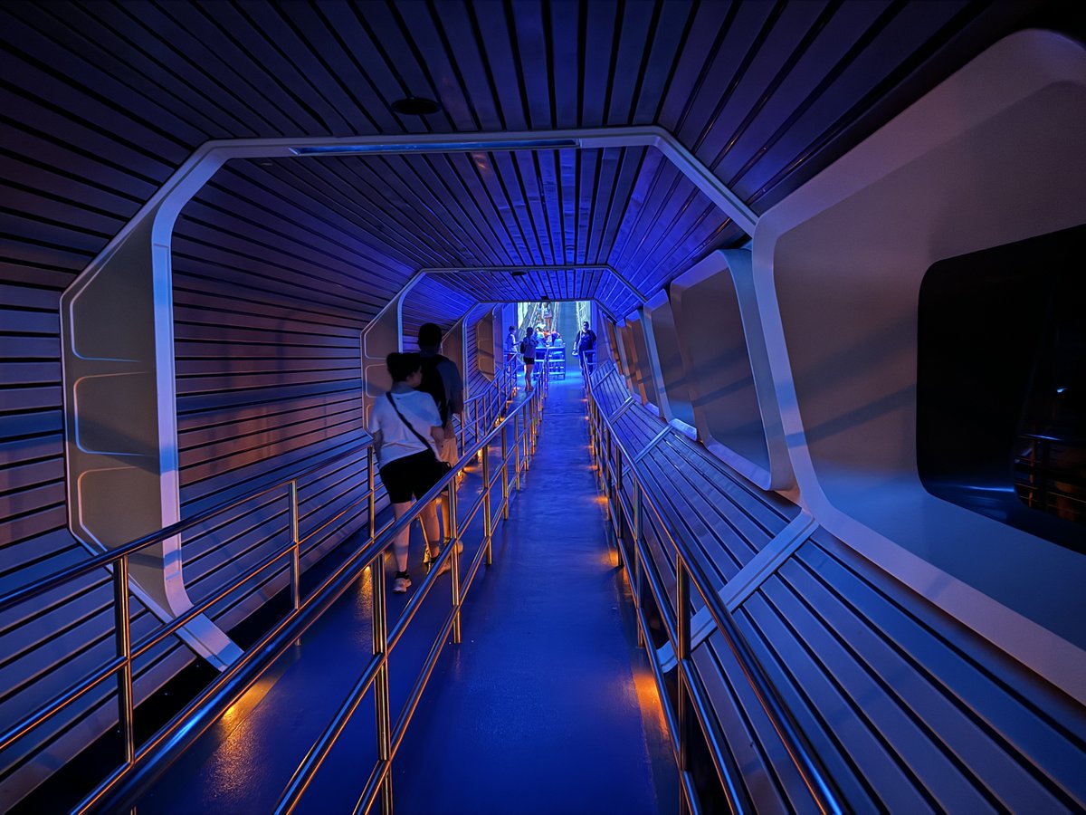 Did you realize the downward bend in Space Mountain's queue is to pass under the railroad track?

Also a picture you can hear.