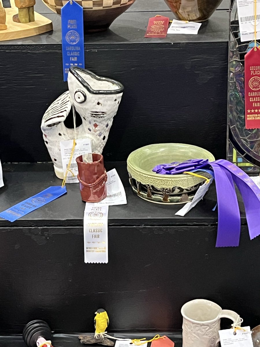 SparkingFIRENC's tweet photo. The real reason why we went to the fair! 

@fire_pottery won 2 ribbons (both first place) and a judges choice!

Her pieces are the white and green ones! https://t.co/nNHTpEDKNE