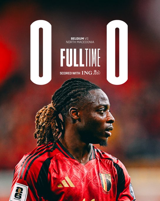 Scoreboard graphic displays Belgium versus North Macedonia with 0-0 score and full-time status. Text reads Scored with ING below. Background shows a stadium setting. Close-up of a male player with long braided hair, wearing a red Belgium national team jersey with Adidas logo and sponsor patches, facing sideways with a serious expression.