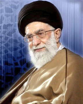 First image shows Mahmoud al-Zahar an older man with gray hair and beard wearing a dark suit white shirt and tie standing at a podium gesturing with hand microphone in front speaking with serious expression Palestinian flag in background glass of water on stand. Second image depicts Ayatollah Ali Khamenei an elderly man with white beard wearing black turban glasses and beige robe seated smiling slightly against blue patterned background.