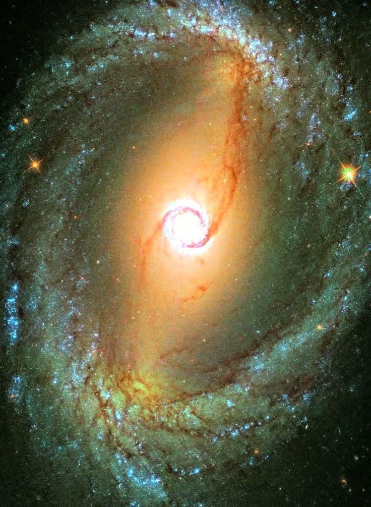 NGC 1512 is a barred spiral galaxy about 38 million light-years away in the Horologium constellation. It displays a double ring structure: a nuclear ring around the center and an inner ring in the main disk. The galaxy has an extended UV disk with at least 200 recent star-forming
