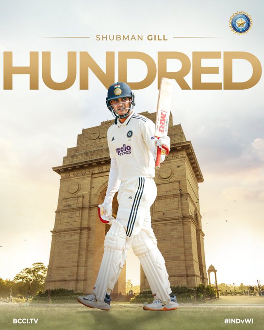 Shubman Gill stands in white cricket uniform holding bat over shoulder wearing blue helmet with India logo on field in front of India Gate monument BCCI logo at bottom.