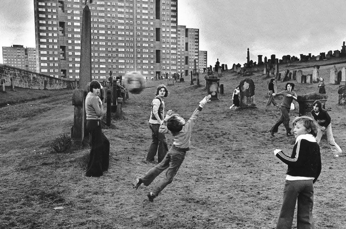 Boys playing football in Sighthill Cemetery, Glasgow, 1976.