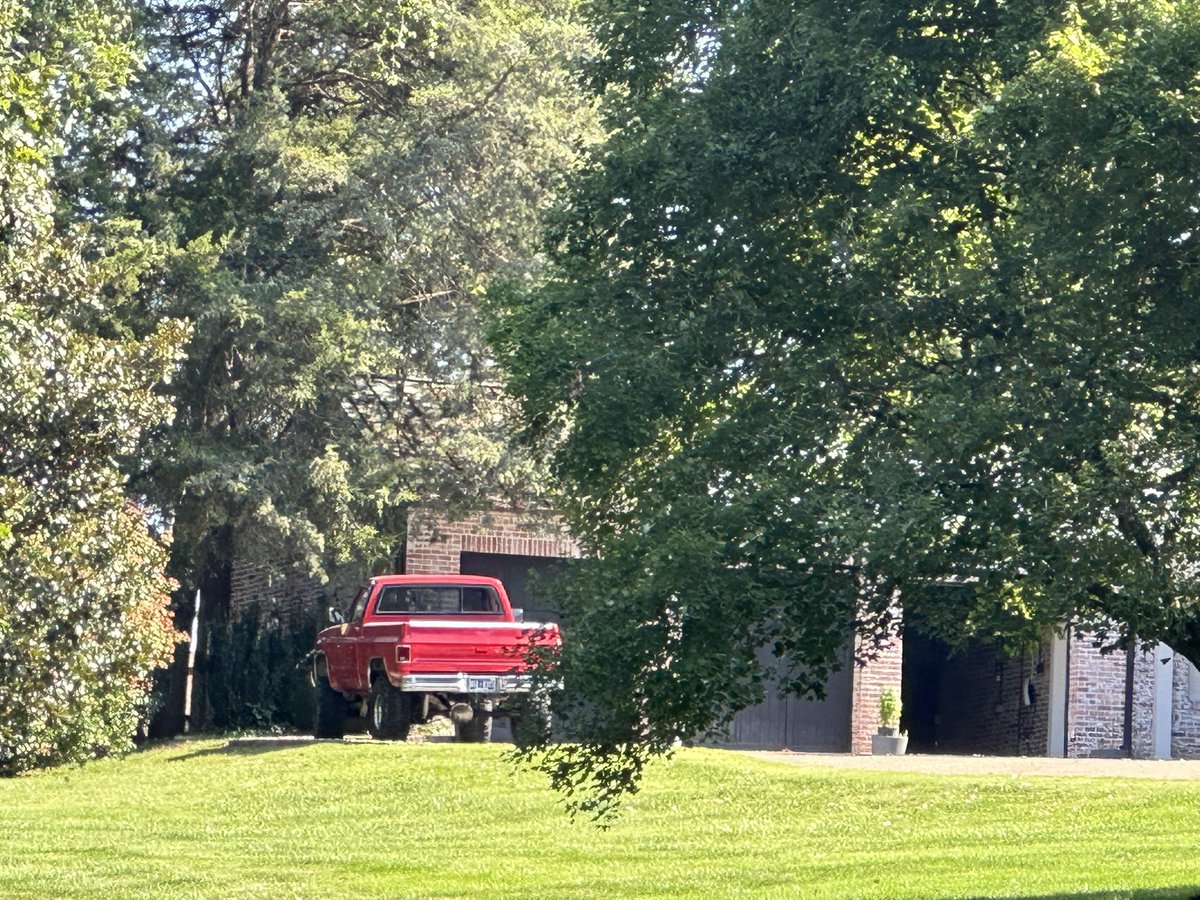 Minnie Pearl’s house with a square body parked near the garage