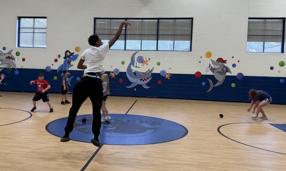 A couple of "our boys" teaching/coaching/helping some of the youngsters how to play basketball at Alberta Smith Elementary School.