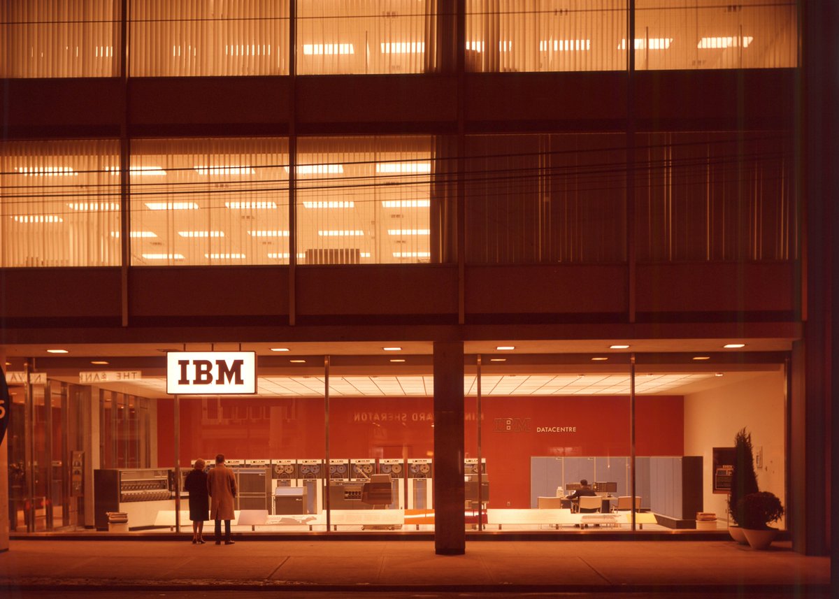 usgraphics's tweet photo. An astonishingly romantic image. 

A couple appears to have paused for longer than usual, in contemplation, marvelling at...cabinets of semiconductors and magnetic tapes. I am guessing it's late night Thursday, 11:42pm. A real life Hopper's Nighthawk... https://t.co/5qckk3u53s