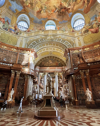 "Austrian National Library". 
Is an extraordinary place to visit and truly a jewel of Vienna. The architecture and atmosphere are breathtaking, offering a profound sense of history and culture.
The impressive State Hall is almost 80 meters long and 30 meters high, and is 
🧵