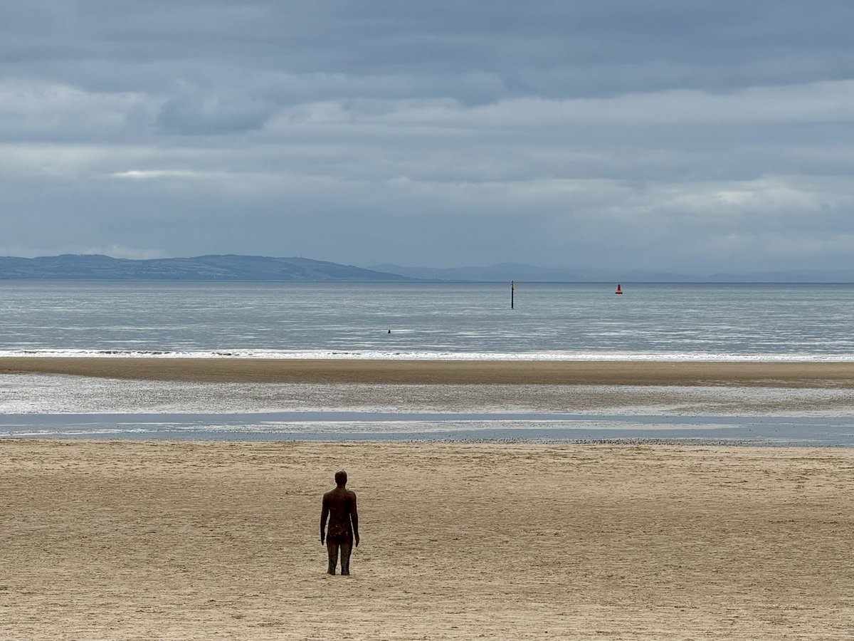 Today, Crosby beach. Weak sunlight filters through the clouds, sending flecks of light across the pewter sea. An incoming tide laps gently at the beach, a quiet murmur of water in the still air, only the piping call of a lone oystercatcher heard above the sound of the sea.