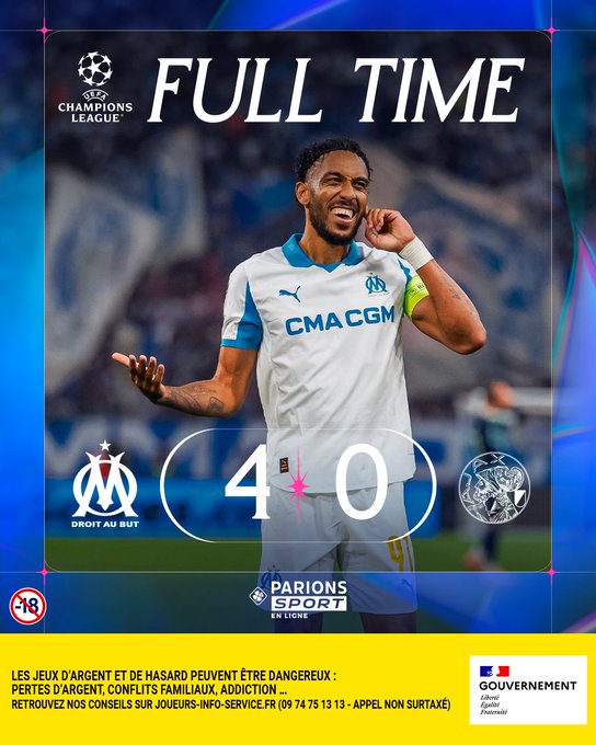 A soccer player wearing a white and blue Olympique Marseille jersey with "CMACGM" text, smiling and gesturing with arms raised. The background shows a stadium setting. Text overlays include "FULL TIME," "4-0," Olympique Marseille logo, and Champions League logo.