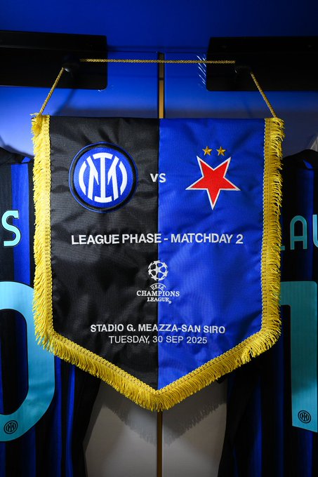 A banner displaying Inter Milan versus Slavia Prague. The banner is divided into black and blue sections with Inter Milan's logo on the left and a red star on the right. Text reads "LEAGUE PHASE - MATCHDAY 2," "UEFA Champions League," "STADIO G. MEAZZA - SAN SIRO," and "TUESDAY, 30 SEP 2025." The banner has yellow fringe and is set against a blue background with additional Inter Milan logos.