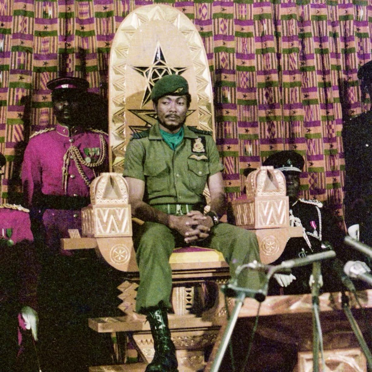 A picture of a stern looking Jerry John Rawlings preparing to hand over power to the democratically elected Dr. Hilla Limann in Parliament House, 1979.