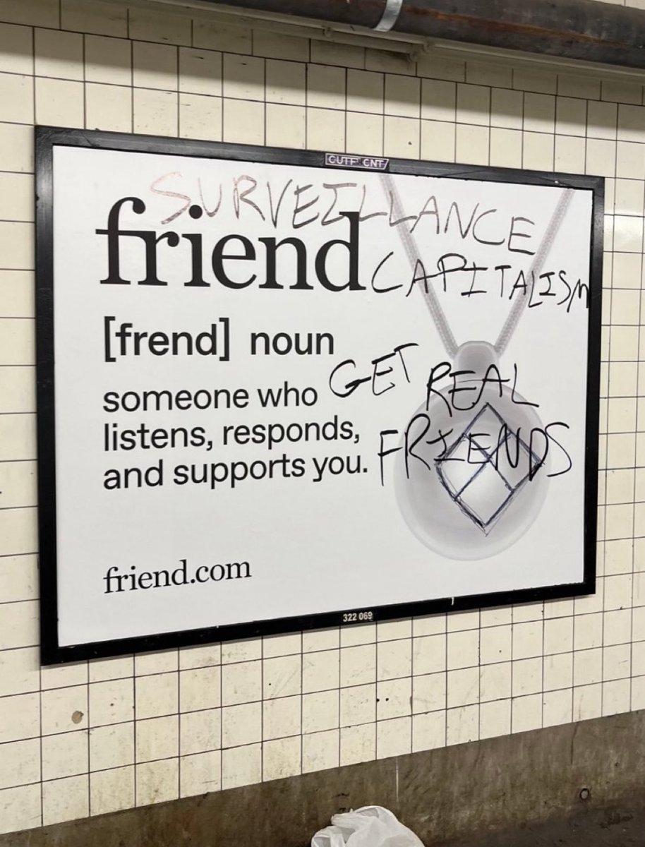 Friend[dot]com marketing campaign for and AI “friend” necklace has been completely defaced in NYC subway and I’m not surprised. 

However, there is another reason I want to share this image. If you haven’t read “The Age of Surveillance Capitalism” by <a href="/shoshanazuboff/">Shoshana Zuboff</a> then you