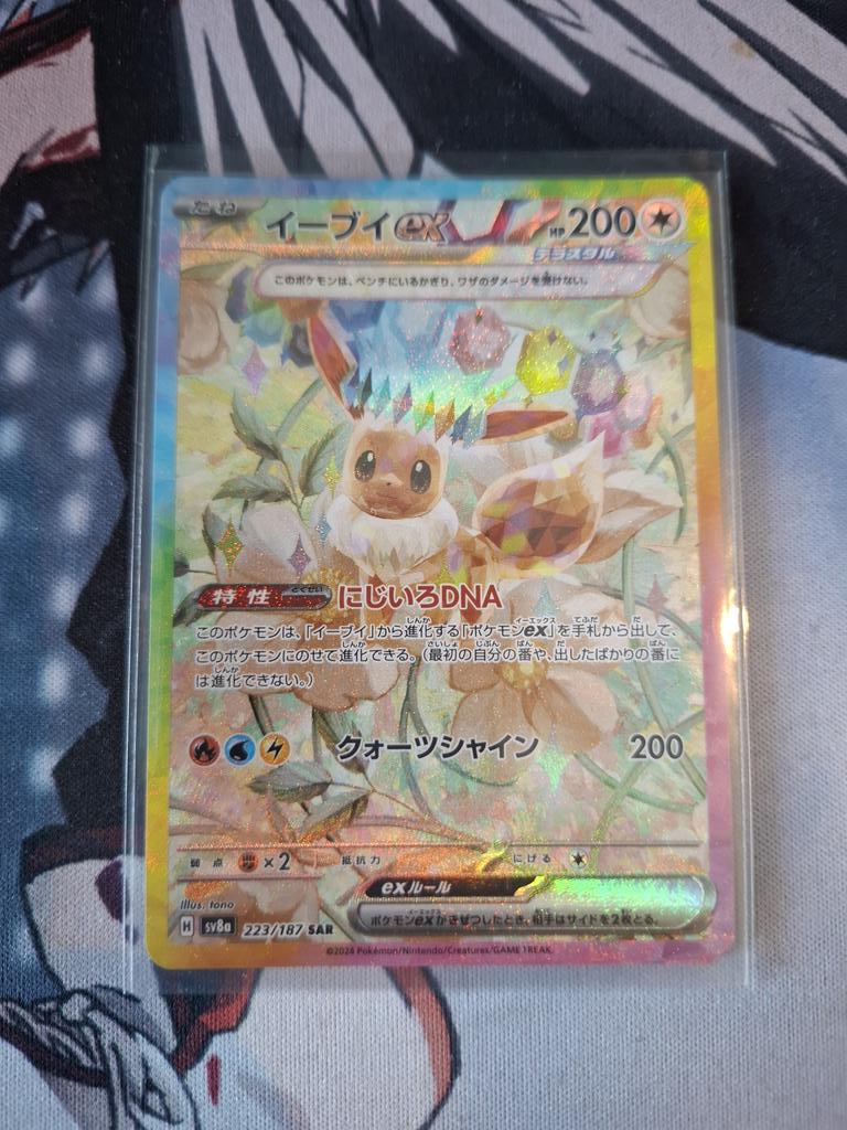 LothisTV's tweet photo. It's been a while since I posted here, cannot believe this happened to me walking home from work. I popped into my local and opened a Demi-god pack  of Terastal Festival!! AHHHHH I am smiling ear to ear right now 🤍🩷🩵 https://t.co/bJXcnMFI86
