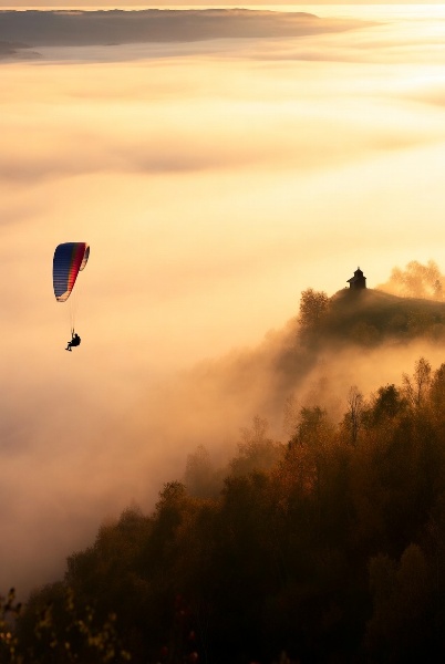 MagicThingsX's tweet image. A misty autumn ridge unfolds with ultra-detailed mist, where a paraglider lands, a fox watches, and a small chapel stands quietly. @grok do you like it? #AutumnMagic #NatureLovers #Paragliding #Wildlife