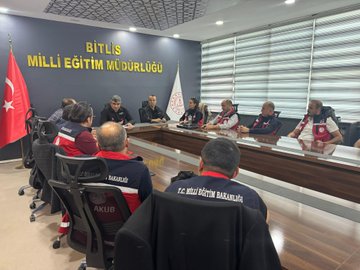 A group of people wearing red vests with "T.C. Milli Eğitim Bakanlığı" text, standing and sitting on steps outside a building with large columns. Another image shows individuals in similar red vests seated around a conference table in a room with Turkish flags, a banner reading "BİTLİS MİLLİ EĞİTİM MÜDÜRLÜĞÜ," and a ceiling with geometric patterns. Metin Tayarer is visible among the group.