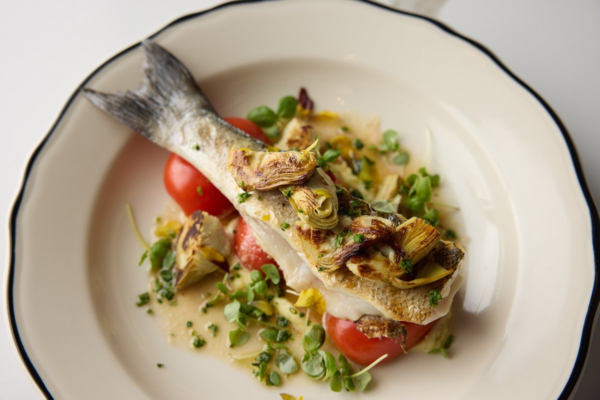 Our Grilled Branzino is made for gathering around. With melted onion, cured tomato, caramelized artichoke &amp;  butter sauce, it’s comforting and layered with flavor. 

Reserve your table: bit.ly/3KCDddq 

#WorkingTitle #OttawaEats #OttawaRestaurants #OttawaDining