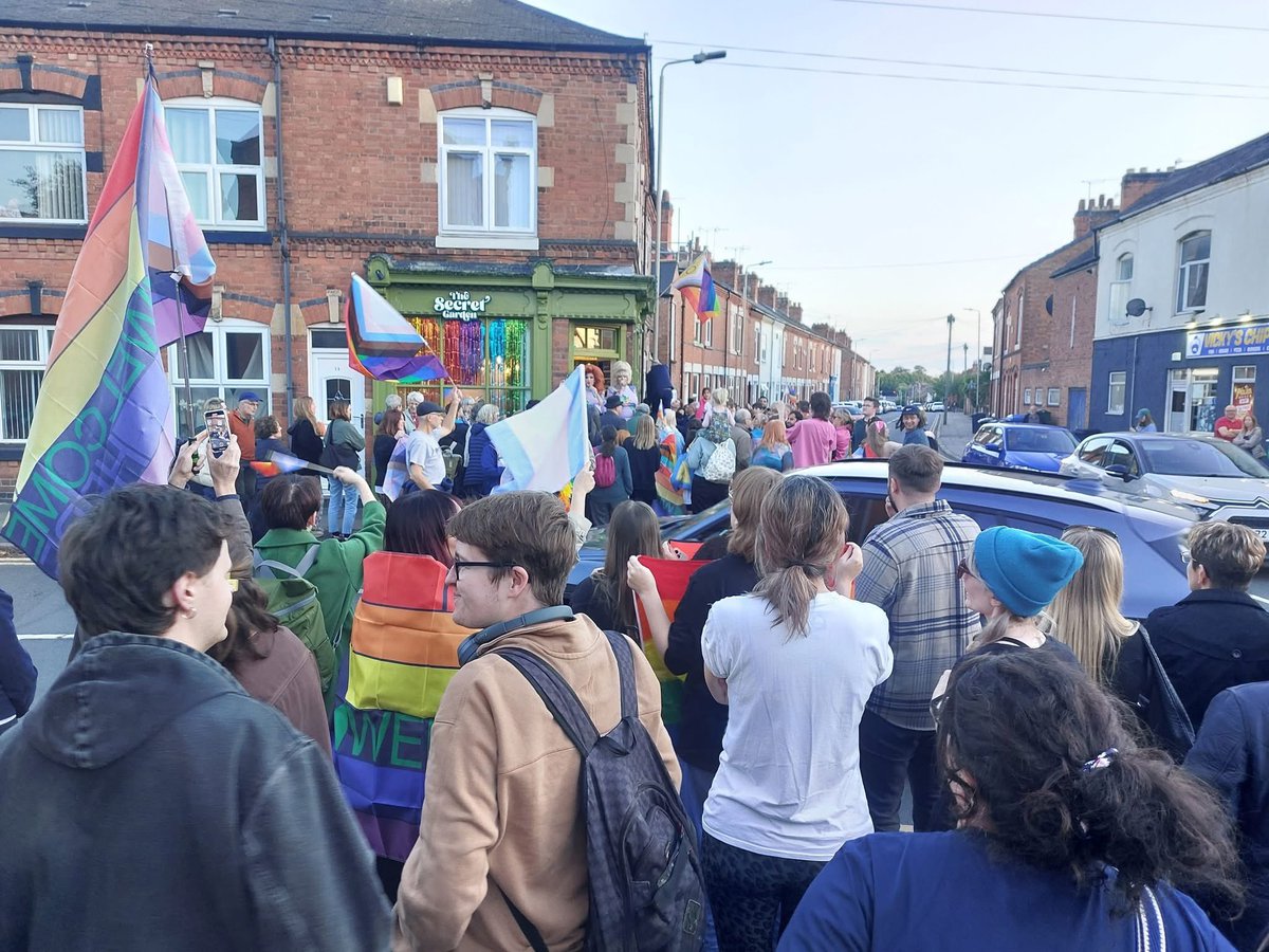 This hair salon had their Pride flag ripped down by a fella in a hood &amp; mask. They had a flag re hanging ceremony, hosted by two Queens, the whole community came out to celebrate. This is who we are.